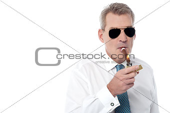 Mature businessman smoking a cigar