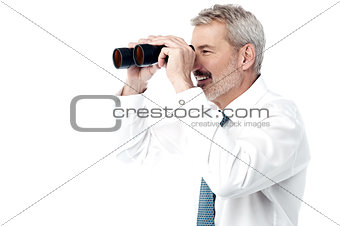 Male executive with binocular