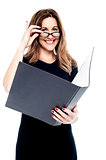Smiling corporate woman holding open folder