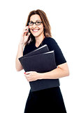 Woman holding a folder and talking on the phone