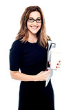 Businesswoman holding folders and hot drink