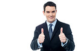Handsome businessman holds his thumbs up