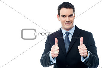 Handsome businessman holds his thumbs up
