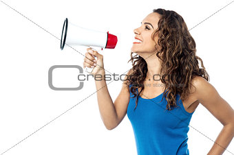 Smiling woman with megaphone isolated on white