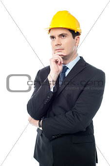 Thoughtful architect wearing a hard hat