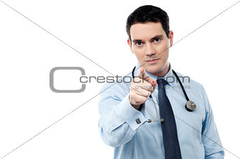 Middle aged doctor pointing at camera