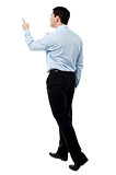 Back view of a middle aged man pointing finger