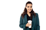Cheerful businesswoman holding a cup
