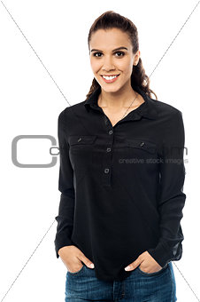 Smiling young woman with hand in pocket