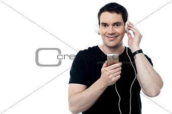 Middle aged man enjoying music on his mobile