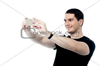 Handsome smiling man taking a selfie