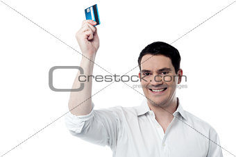 Smiling man holding up his credit card