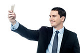 Man taking pictures of him self with smartphone