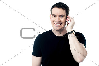 Casual smiling man calling on the phone