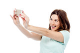 Attractive woman is taking photos with cell phone