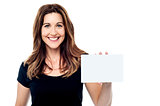 Attractive businesswoman holding a blank card