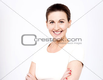 Smiling women with arms crossed over white