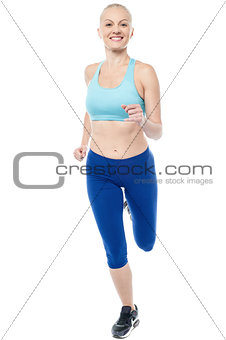 Young female fitness model running