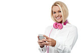 Happy woman with cell phone and headset