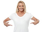 Smiling woman pointing her stomach