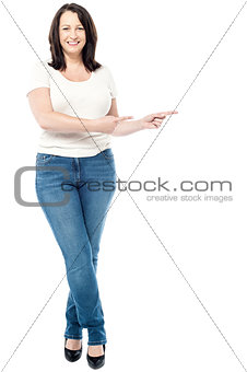 Happy woman pointing copy space