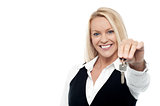 Attractive smiling woman holding a key