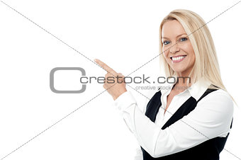 Businesswoman pointing, isolated on white