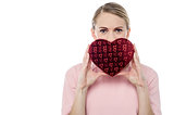 Woman holding gift box in form of heart