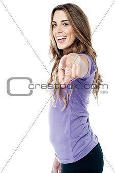 Trendy girl pointing towards you