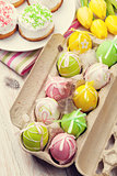 Easter with yellow tulips, colorful eggs and traditional cakes