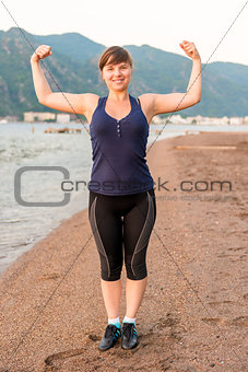 cheerful young athlete and strong arms