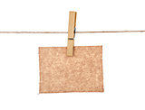 sheet of kraft paper hanging on a rope with clothespin on a whit