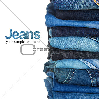Stack of blue and black jeans as a background