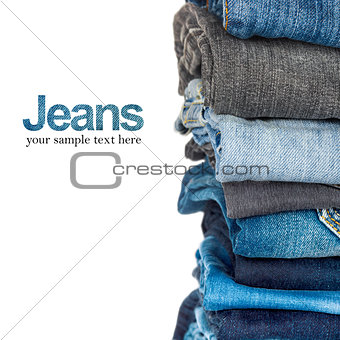 Stack of blue and black jeans as a background