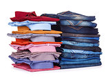 stack of colorful office shirts and jeans on a white background