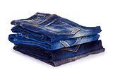 stack of blue jeans on a white background