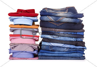 stack of colorful office shirts and jeans on a white background