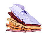 Stacks of many colored clothes isolated on a white background