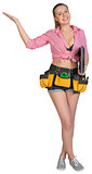 Woman in tool belt, with laptop under her armpit, showing empty palm