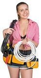Woman in tool belt holding coils of cable
