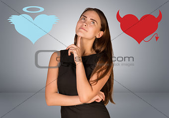 Woman musing between angel and devil hearts