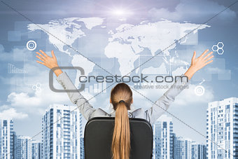 Businesswoman sitting with her hands outstretched against urban background
