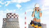 Woman in hard hat adjusting protective glasses