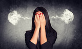 Close-up portrait of businesswoman hiding face in her hands, with smoke from ears