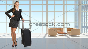 Businesswoman with travel bag in vast interior
