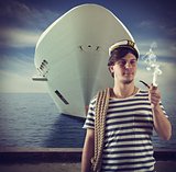 Sailor smokes in front of ship
