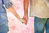 Composite image of couple holding hands in park