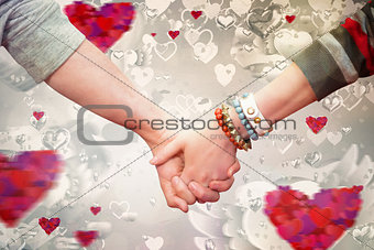 Composite image of students holding hands