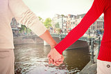 Composite image of couple holding hands rear view