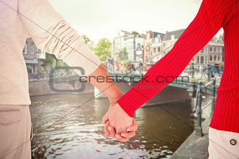 Composite image of couple holding hands rear view
